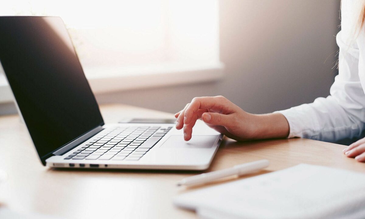 A realtor in front of her laptop, working with her blog.