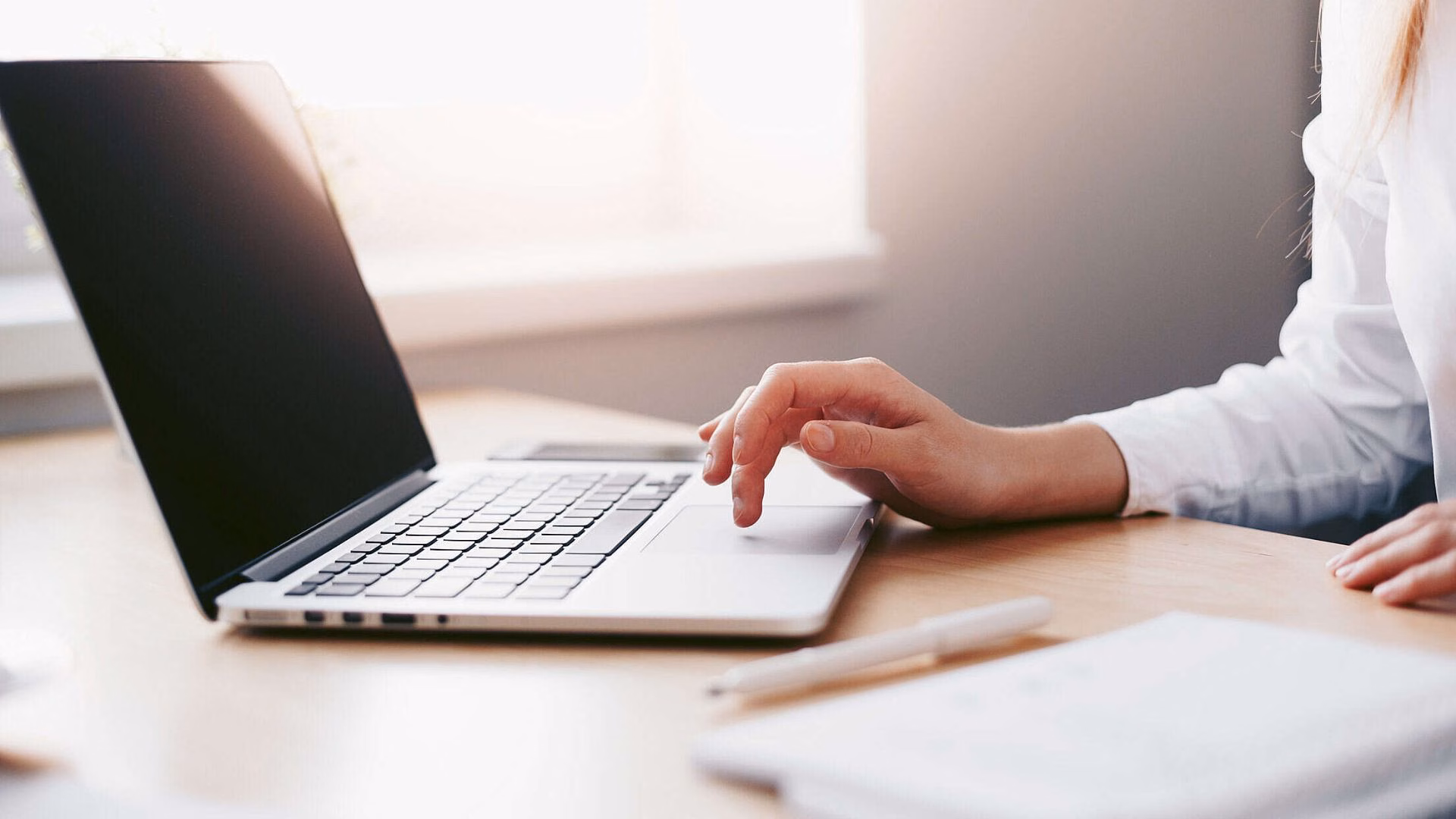 A realtor in front of her laptop, working with her blog.