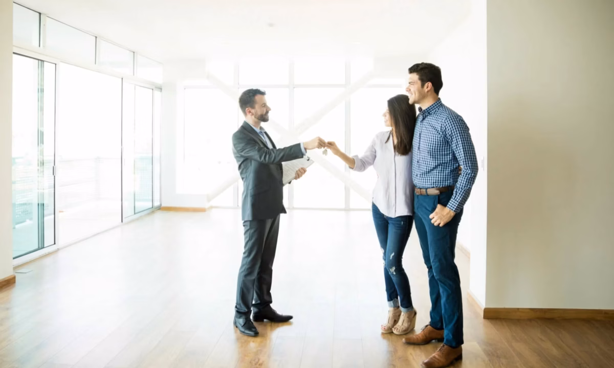 A real estate broker endorses the key to his client's new home in California.