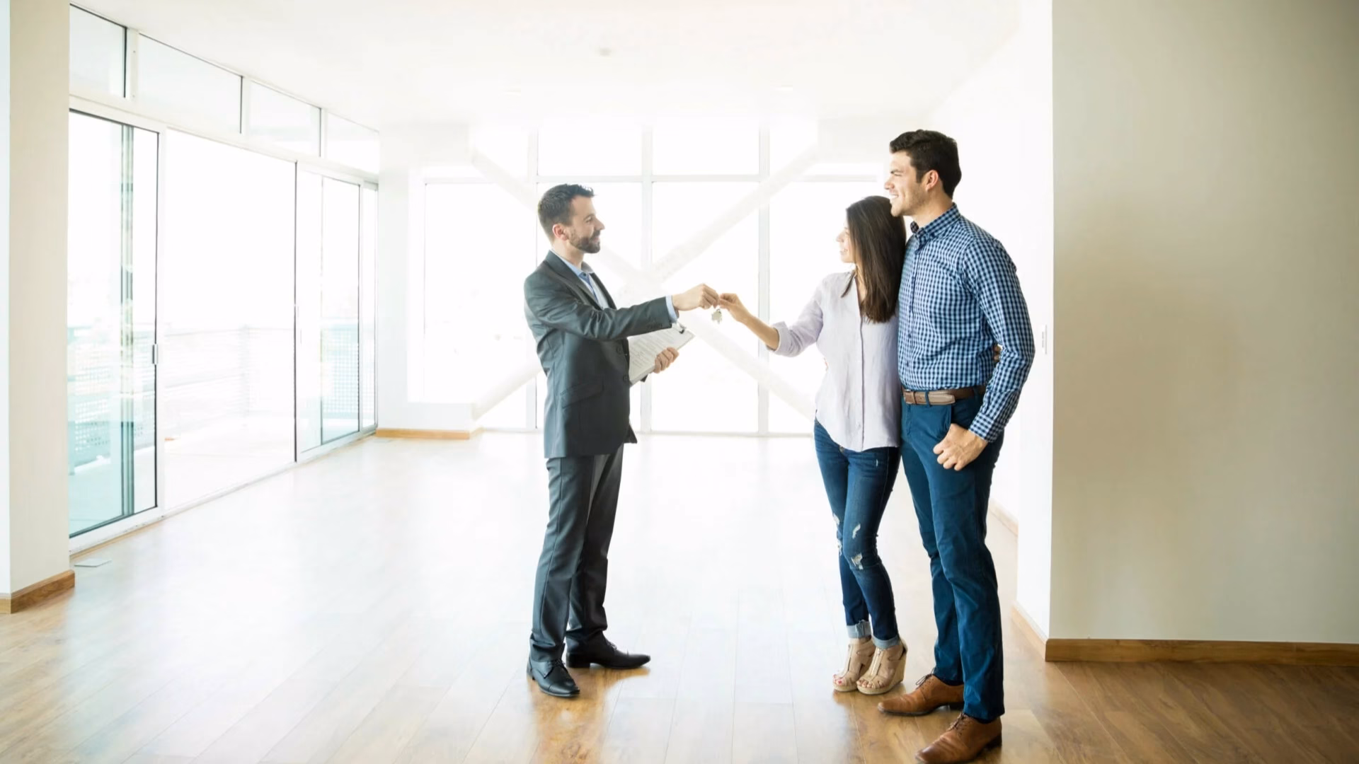 A real estate broker endorses the key to his client's new home in California.