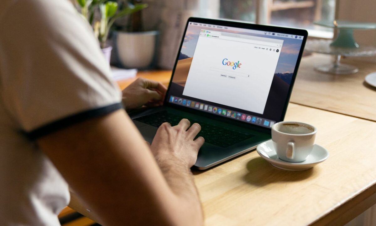 A realtor searches Google on his laptop to learn more about boosting his website's SEO value.