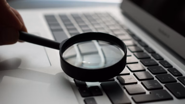 A magnifying glass over a keyboard depicts a particular search tool.