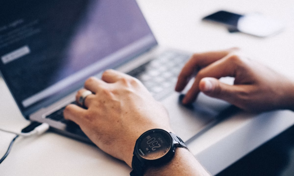 A realtor sits in front of his laptop, preparing for the new age of marketing in 2021.