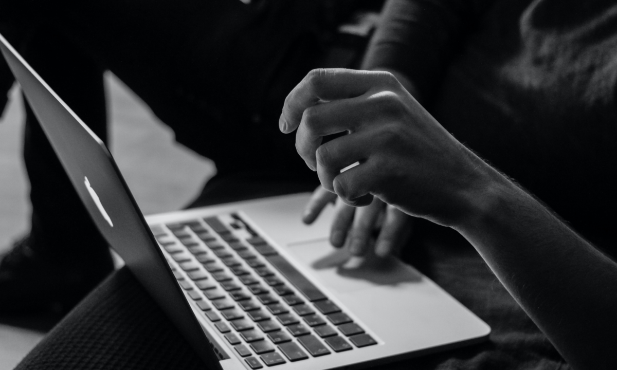 hands typing on laptop for blog about how to host a virtual open house