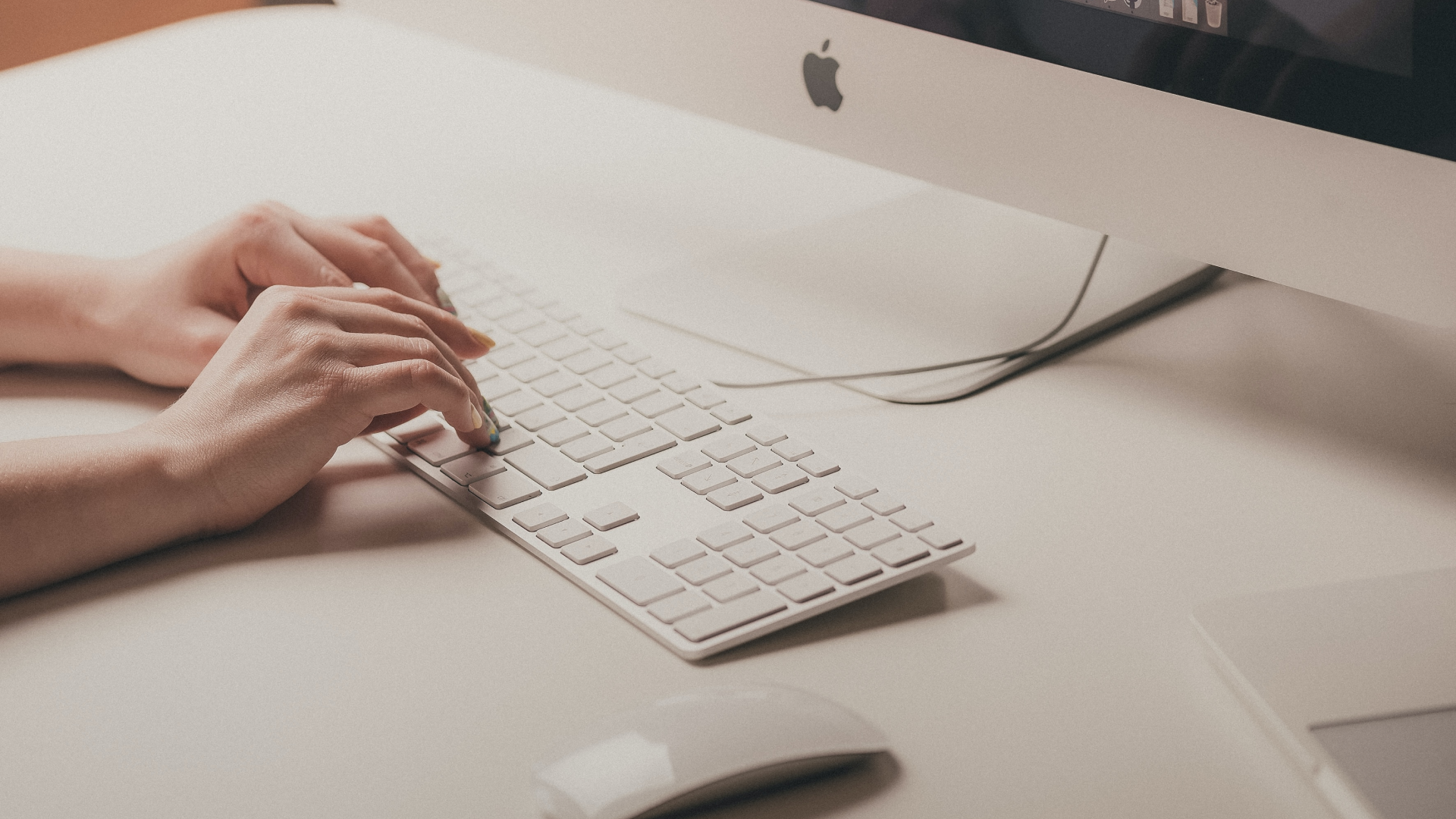 hands typing on keyboard