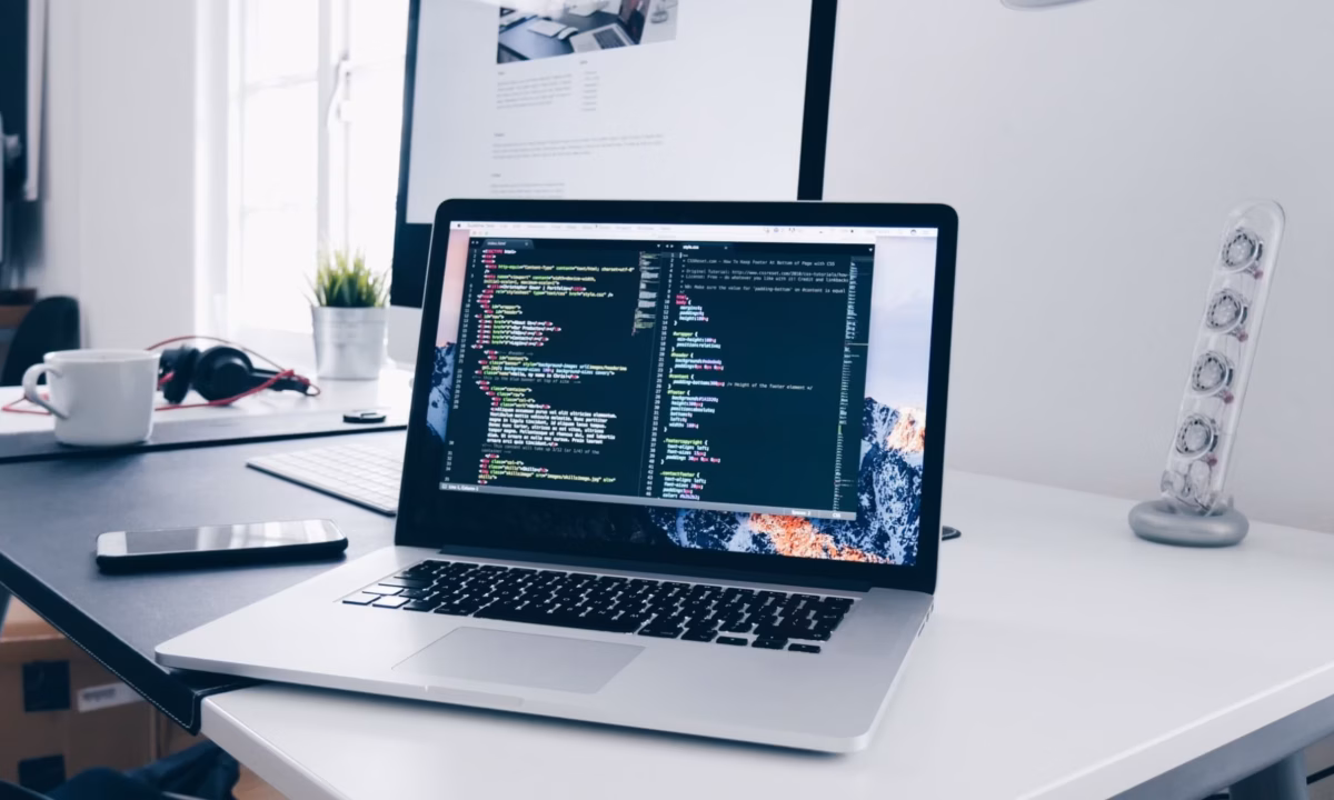 A laptop showing a website's backend, full of codes for pop-ups