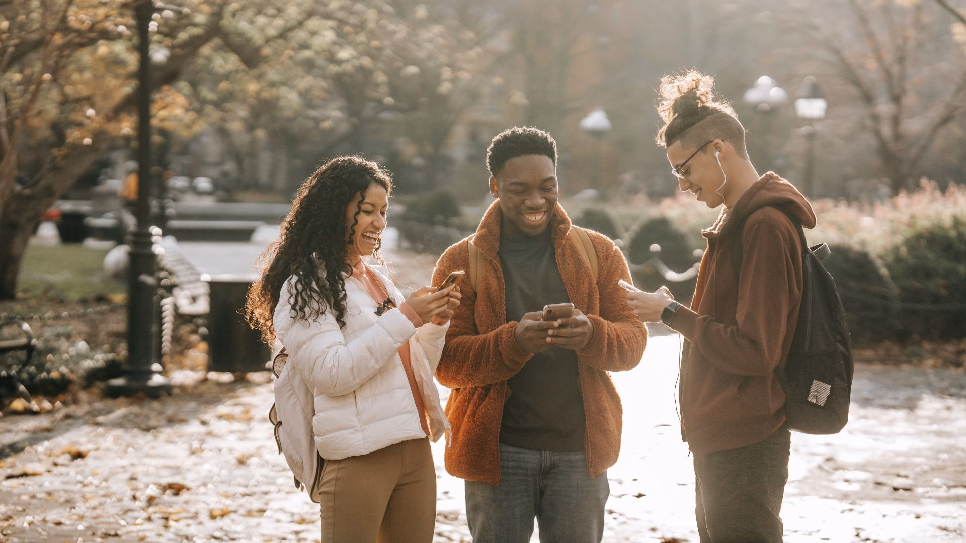 A group of people casually browsing social media on their mobile phones.