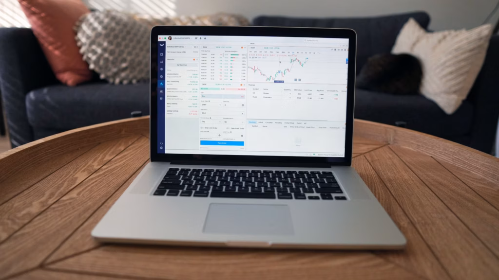 A laptop showing multiple diagrams of different financial market reports online.