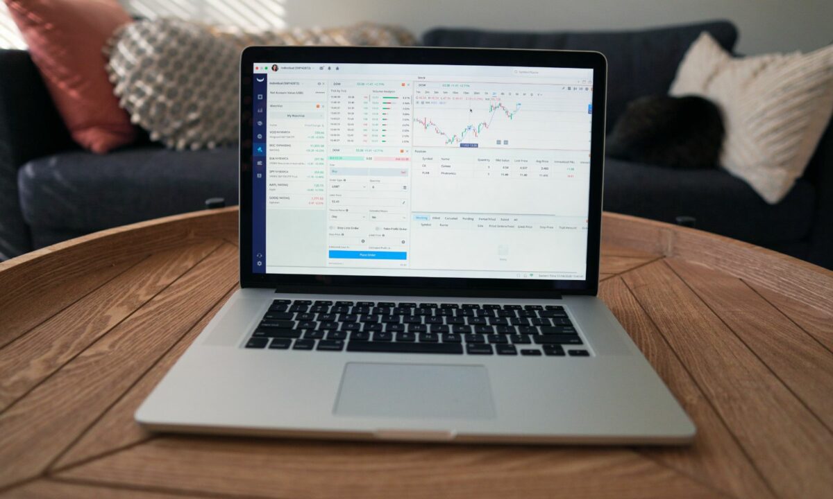 A laptop showing multiple diagrams of different financial market reports online.