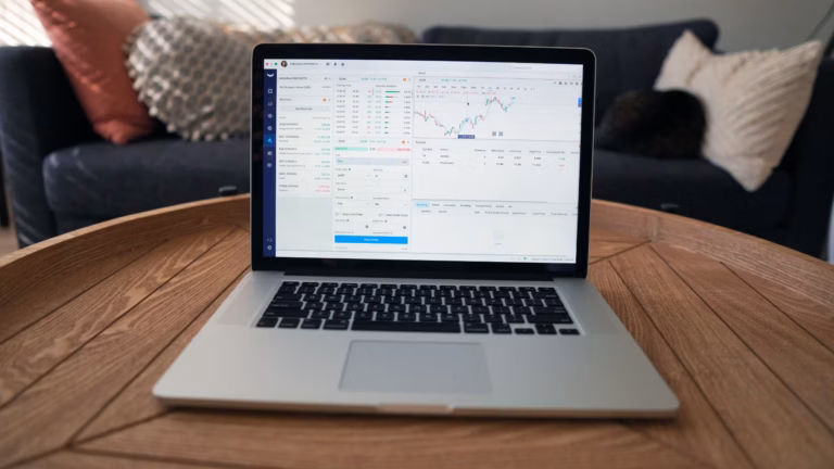 A laptop showing multiple diagrams of different financial market reports online.
