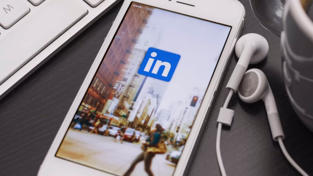 A mobile phone showing a wallpaper with the LinkedIn logo.