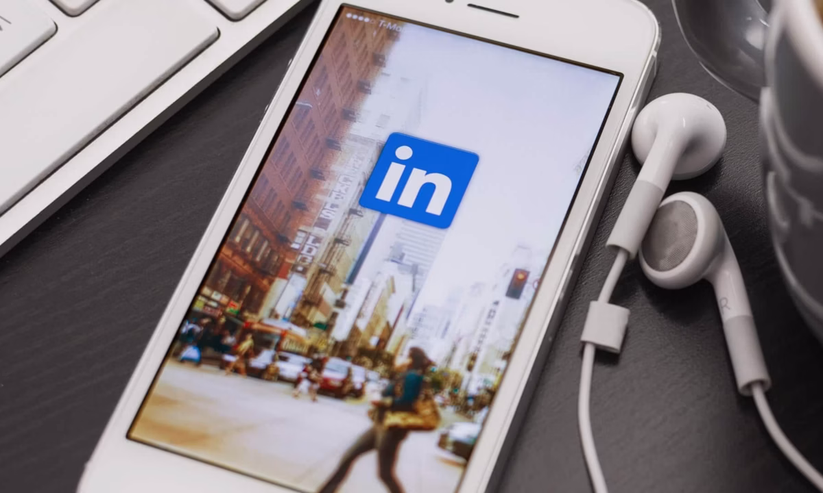 A mobile phone showing a wallpaper with the LinkedIn logo.