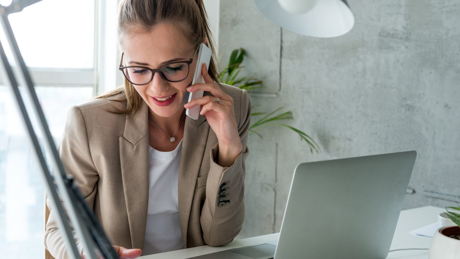 An agent is on the phone managing her real estate transaction coordination
