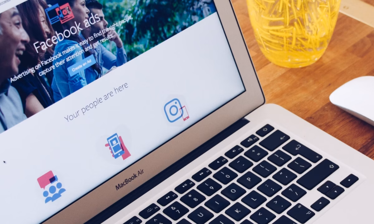 A MacBook showing the Real Estate Facebook Ads landing page from Meta.