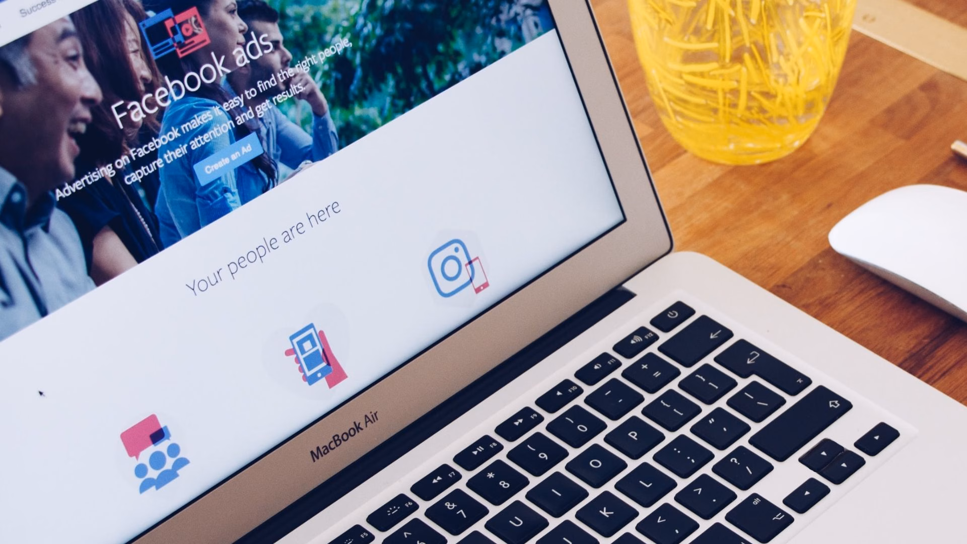 A MacBook showing the Real Estate Facebook Ads landing page from Meta.