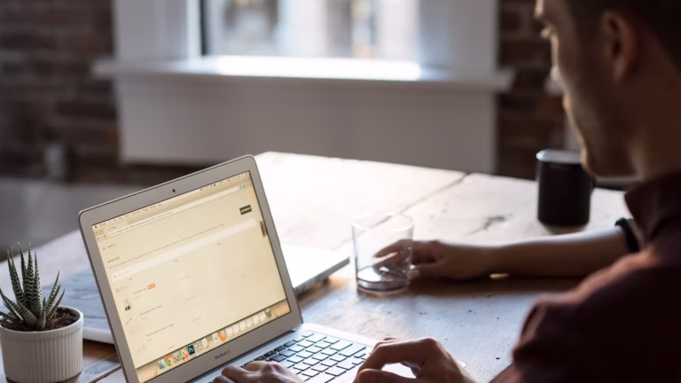 A real estate agent searches online for the top real estate domain names to find the best one for his website.