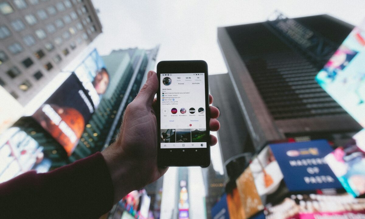 real estate agent holding a phone up to a city skyline