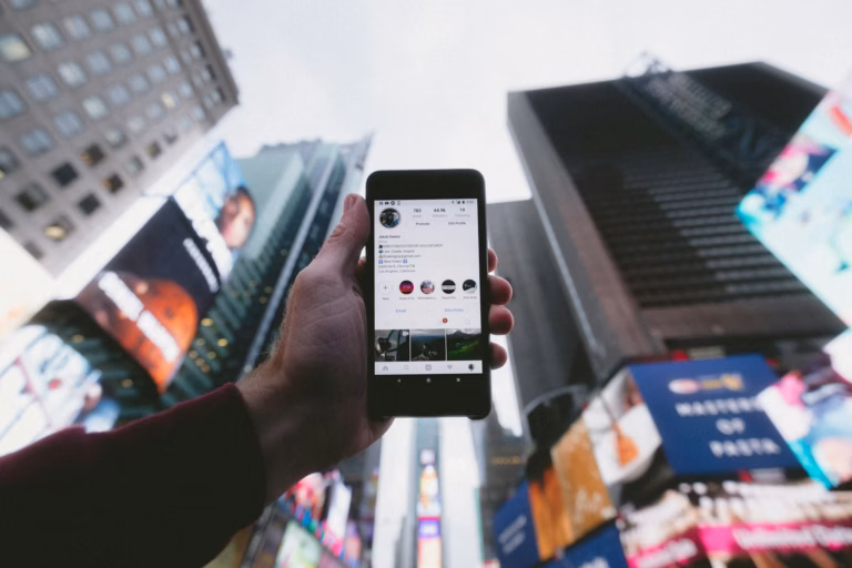 real estate agent holding a phone up to a city skyline