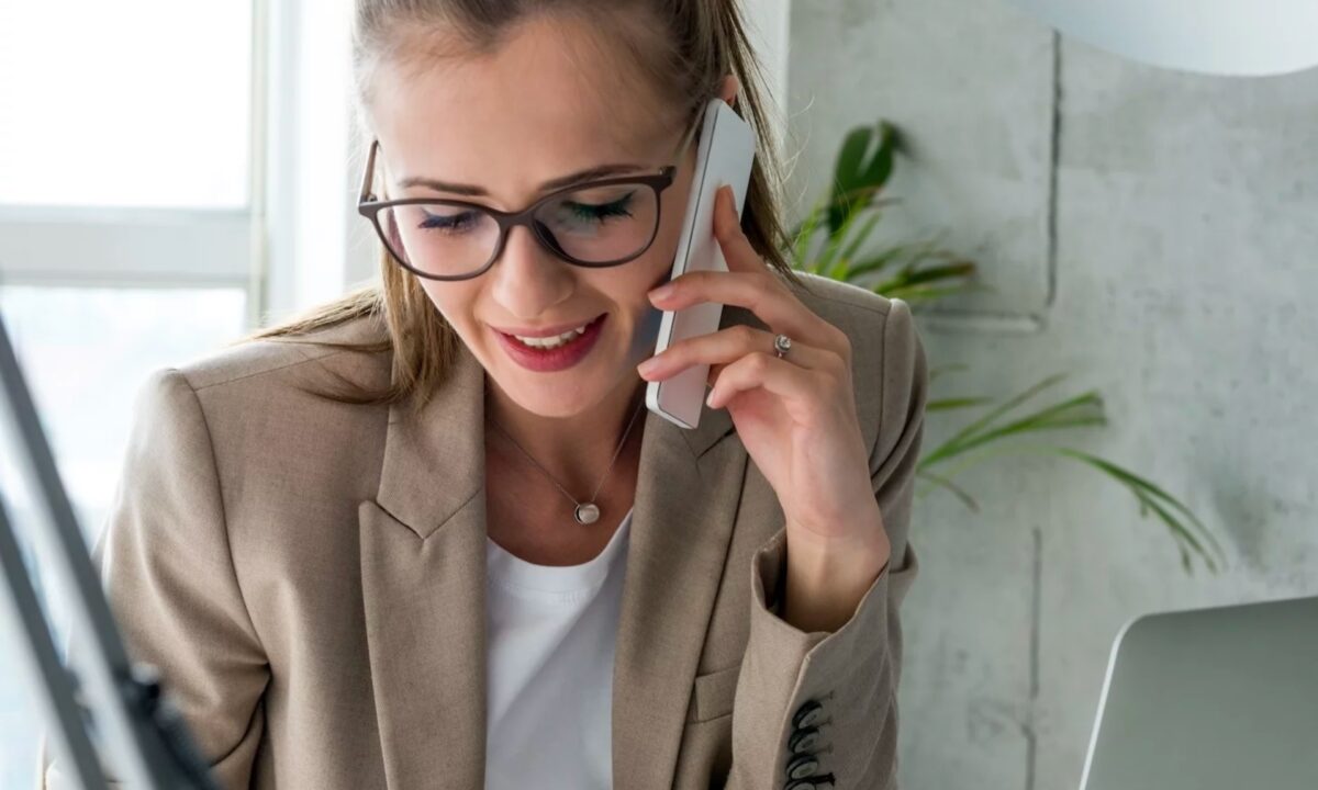 A real estate agent calls a prospect client on her mobile phone using a real estate cold calling script from the internet.