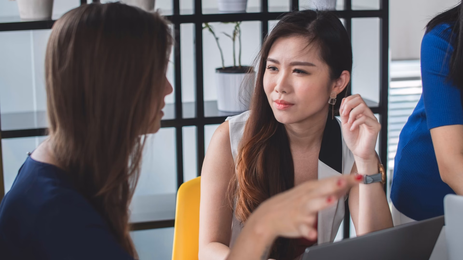 Real estate agent sits with a client listening to what they want as an example of client relationship marketing
