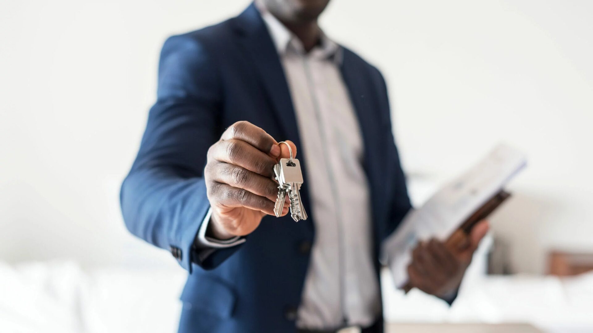 A real estate agent endorsing a key to a real estate property.