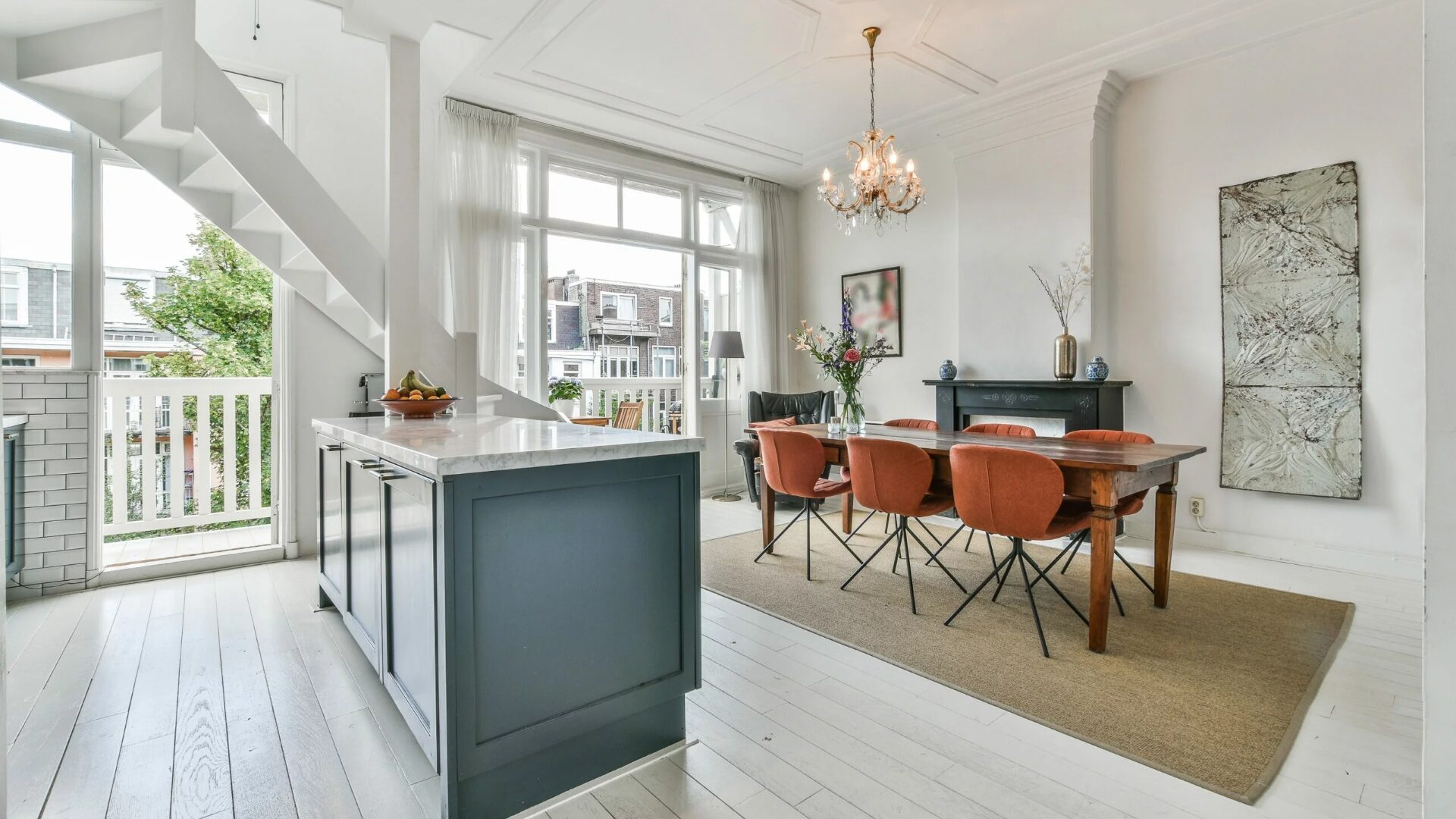 A clean and modern view of a kitchen island with dining area.