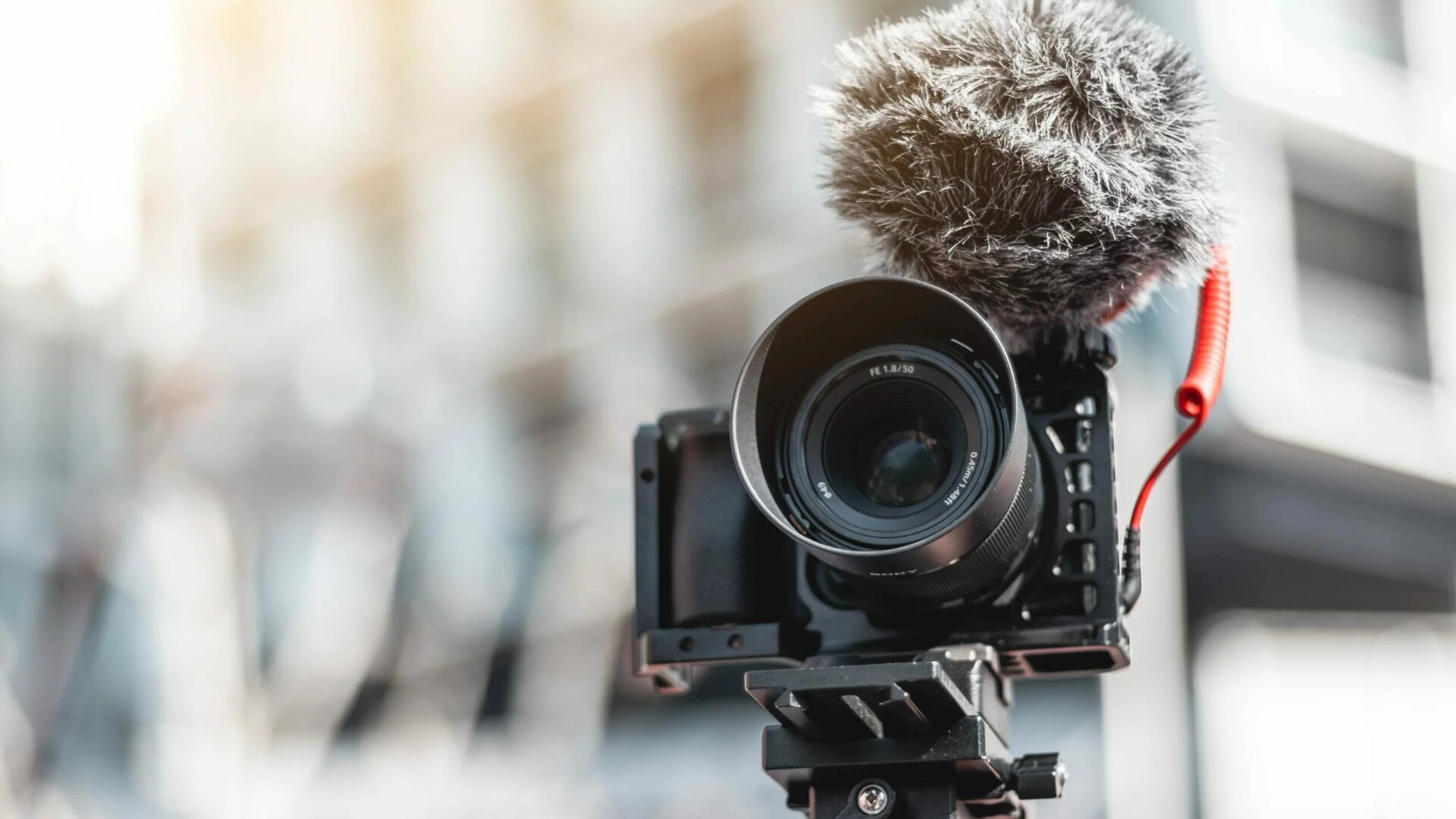 A digital camera on a tripod is used for real estate videography.