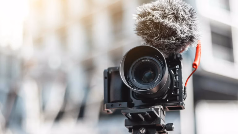 A digital camera on a tripod is used for real estate videography.