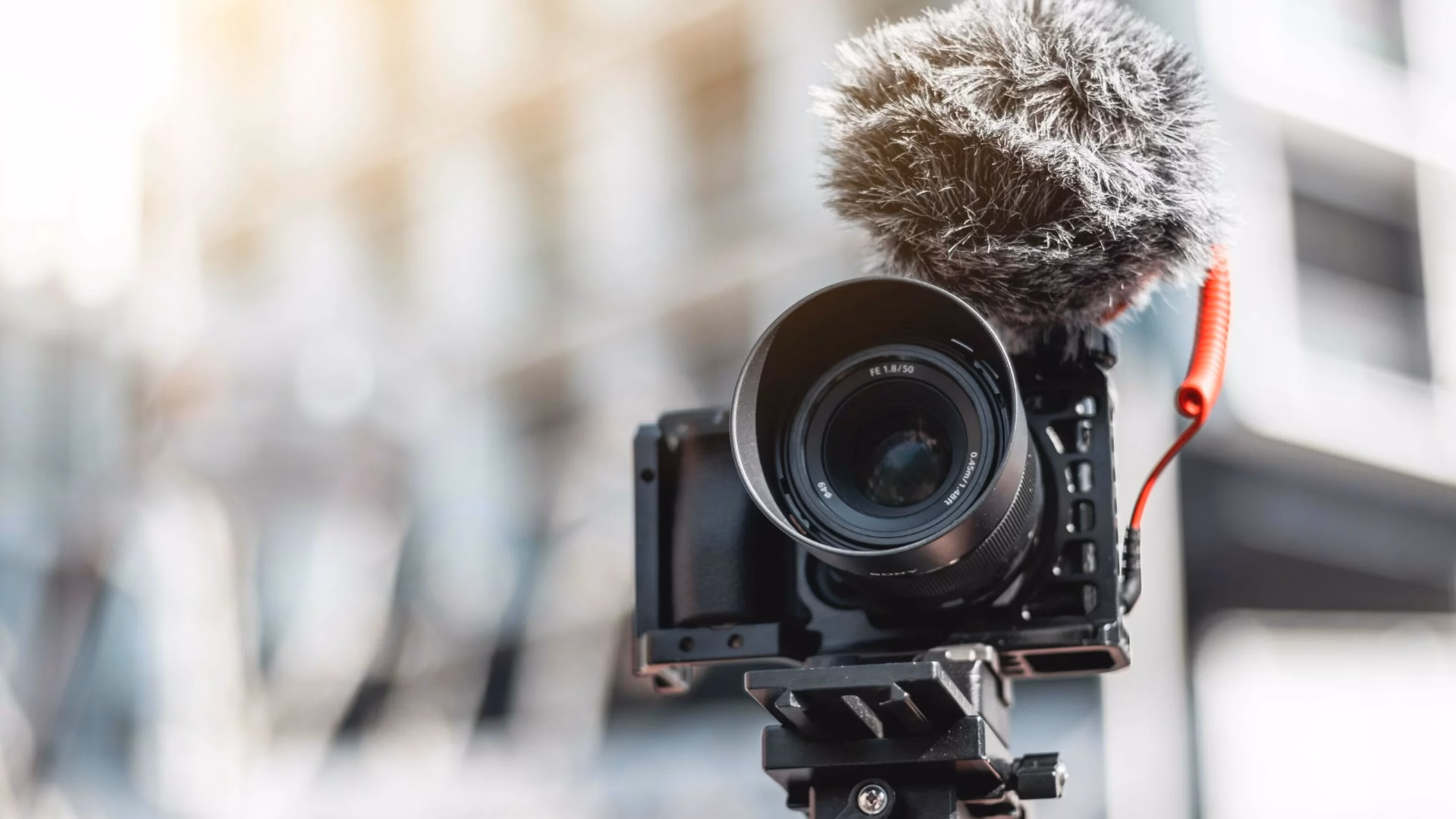 A digital camera on a tripod is used for real estate videography.
