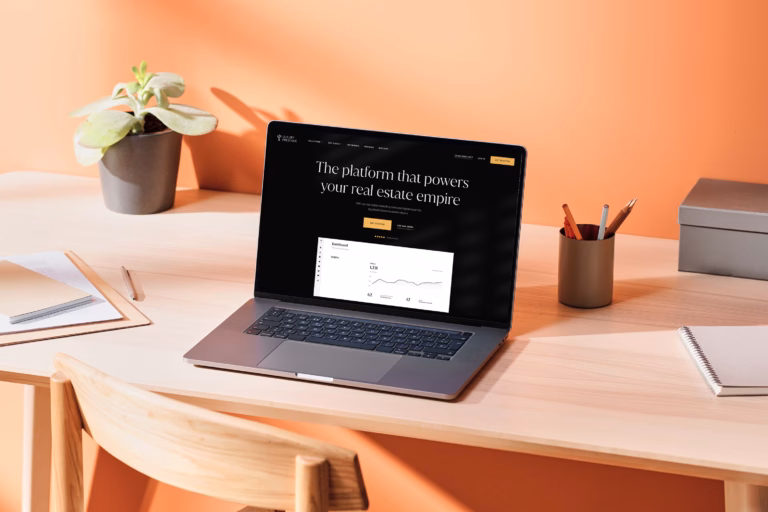 A laptop on a desk with a webpage open about "Building the Perfect Agent Website" with Luxury Presence.