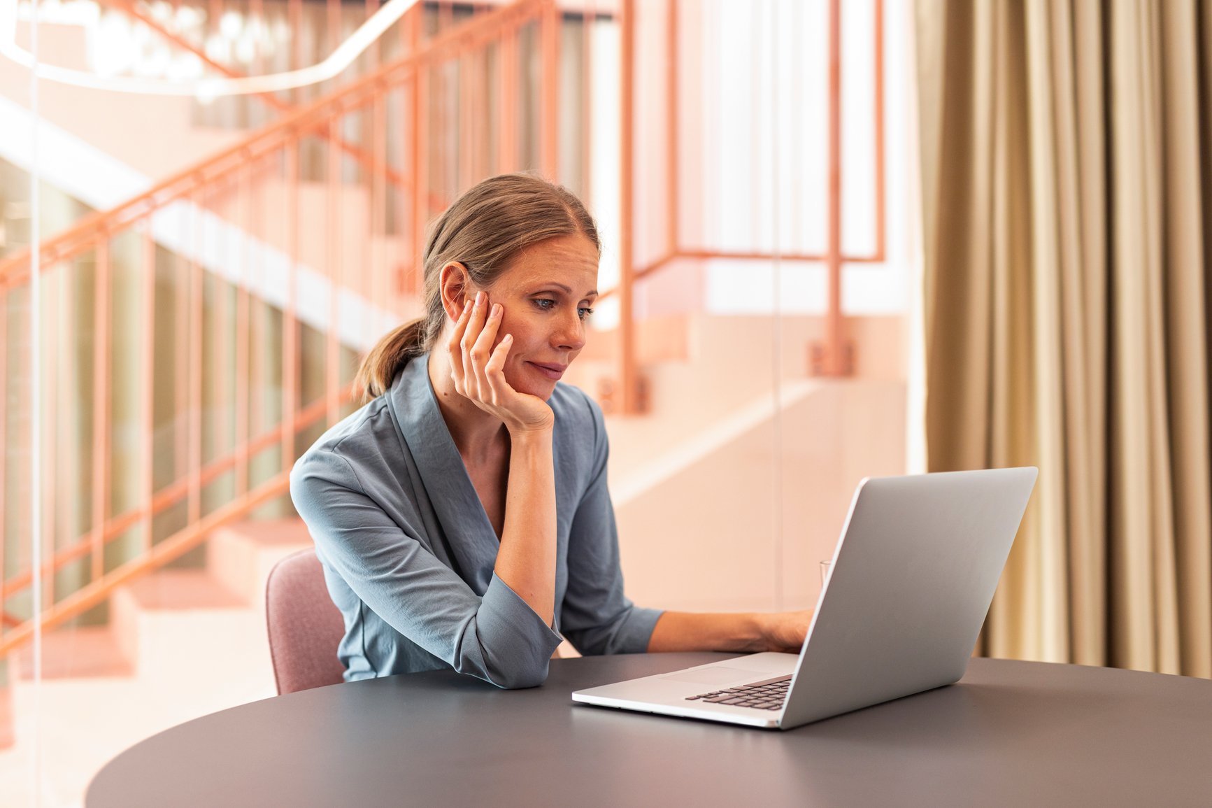 Female realtor looking at real estate website SEO applications on her laptop.