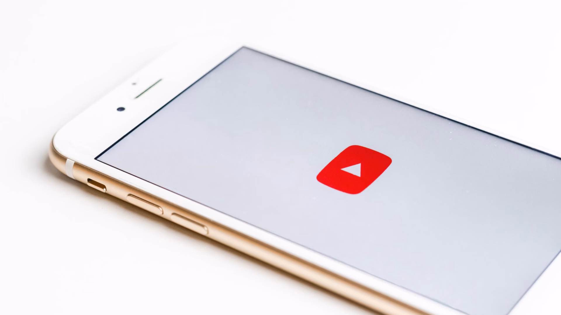 A mobile phone showing the logo of YouTube for blog about starting a real estate youtube channel.