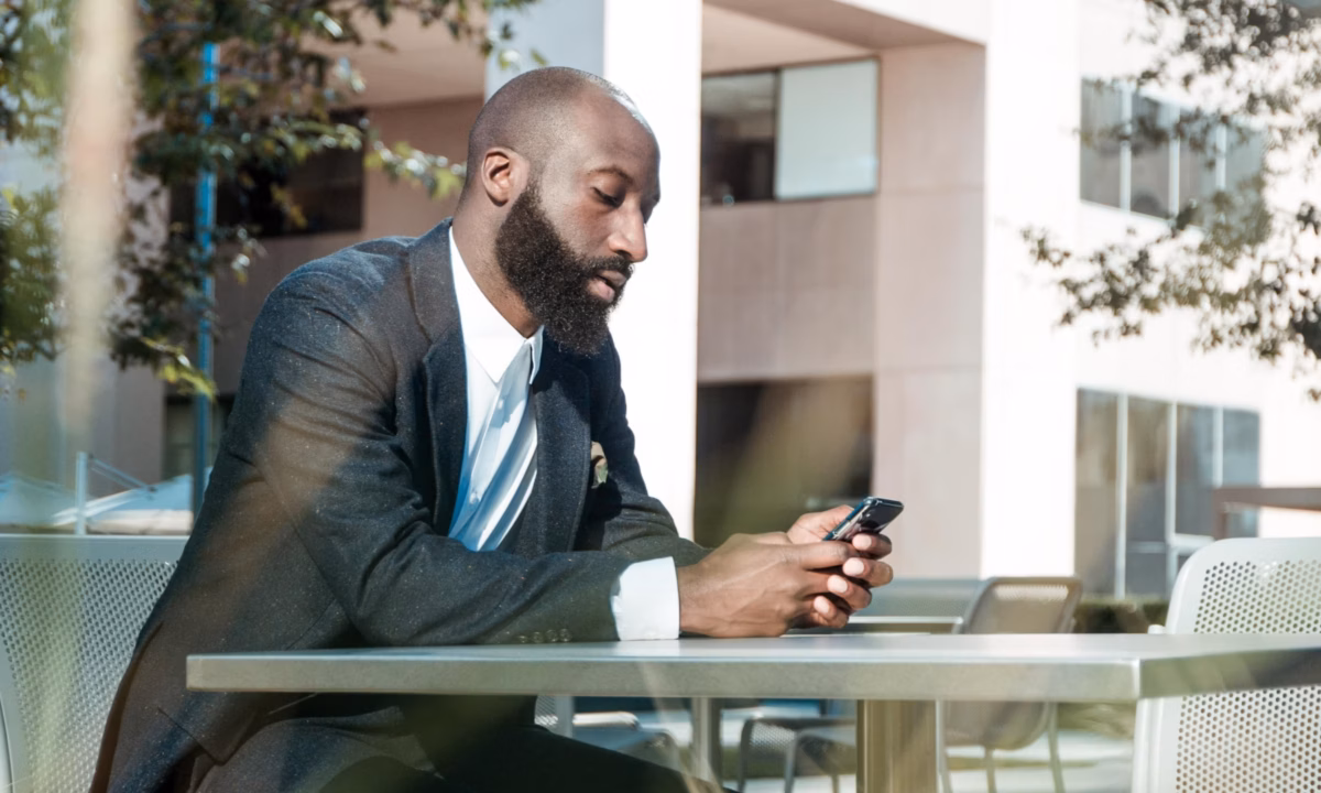 real estate agents looking up top real estate apps on his phone