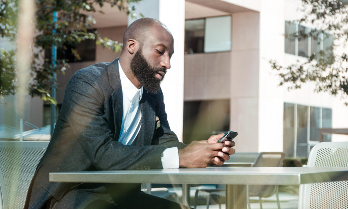 real estate agents looking up top real estate apps on his phone