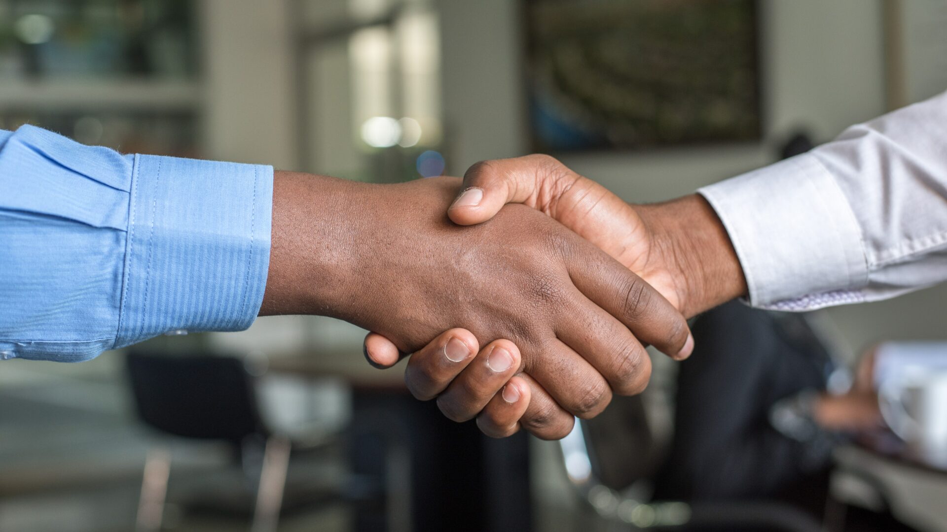 real estate agent shaking hands with past client who just provided a referral