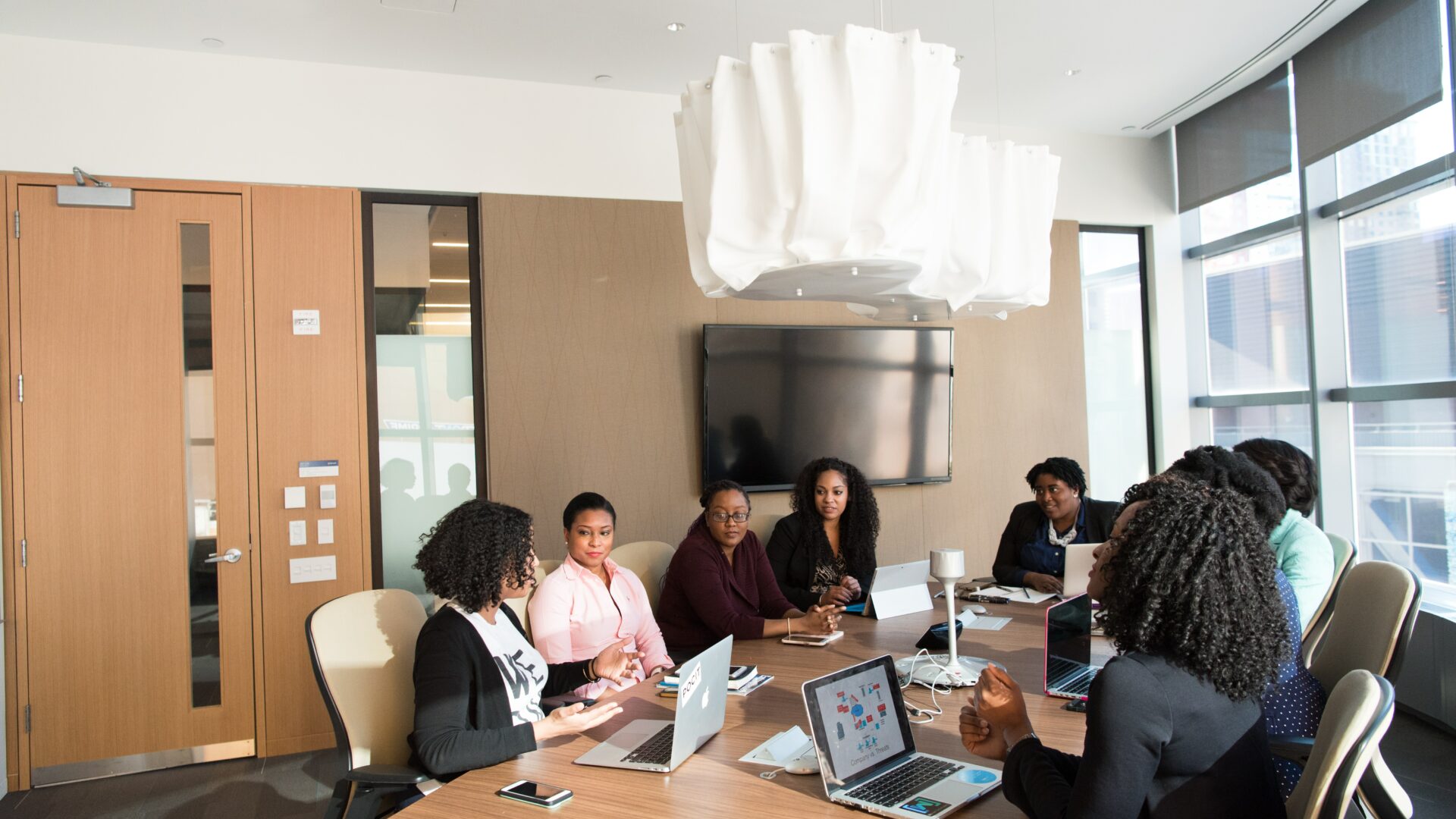 A team of realtors is shown collaborating and brainstorming strategies to grow your audience and reach more potential clients.