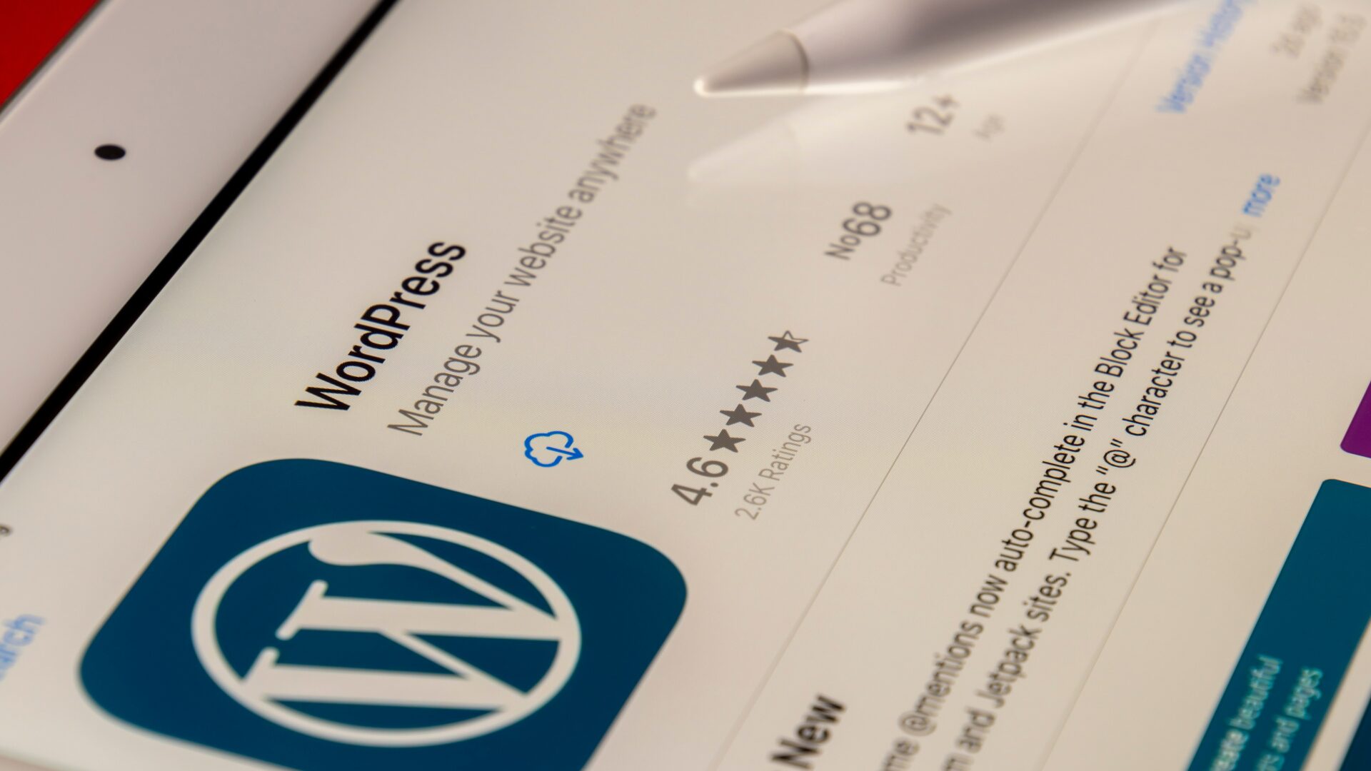 A tablet displays a preview of a real estate website built on WordPress CMS.