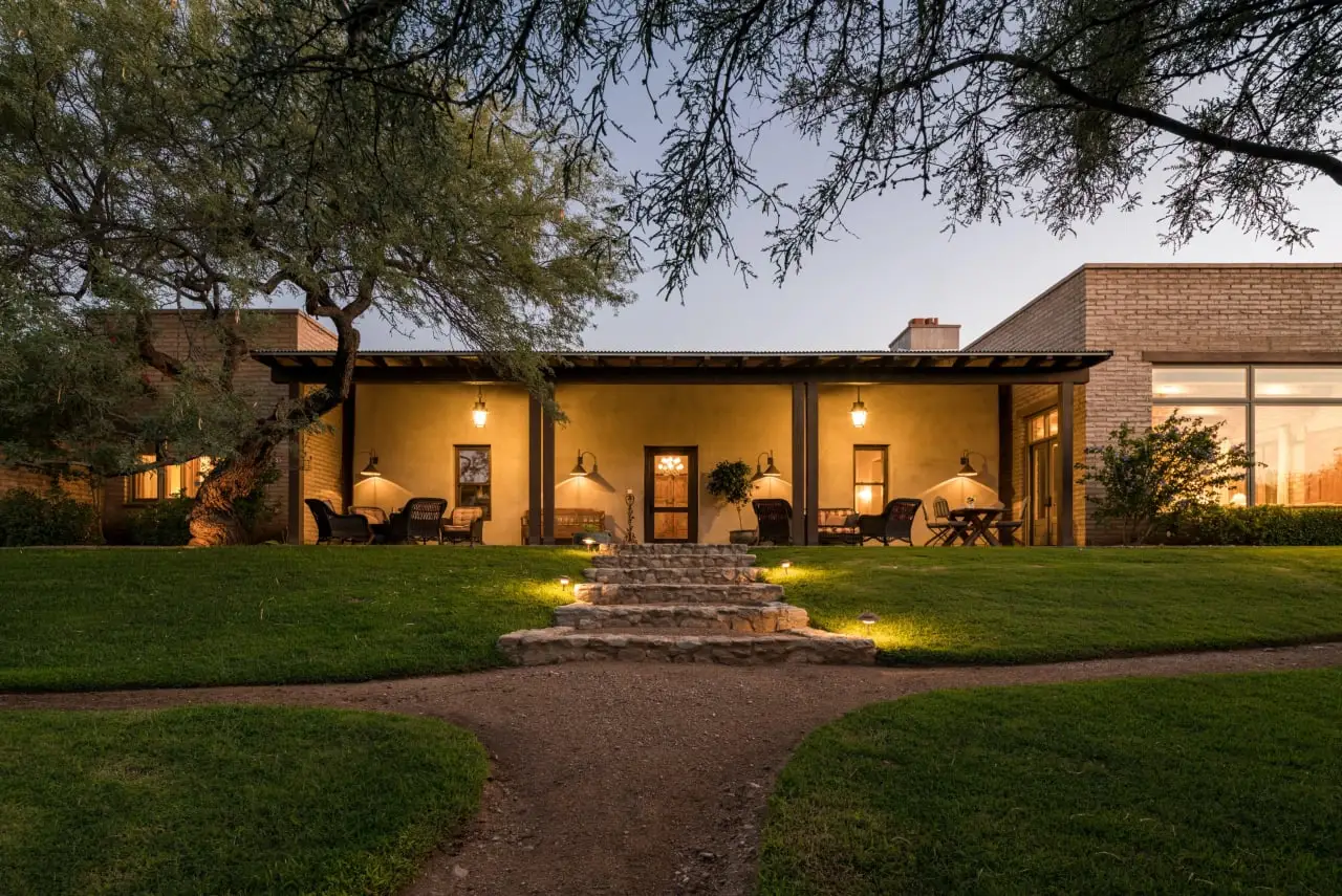 Example of real estate photography featuring a ranch house exterior during dusk lit by warm yellow lights