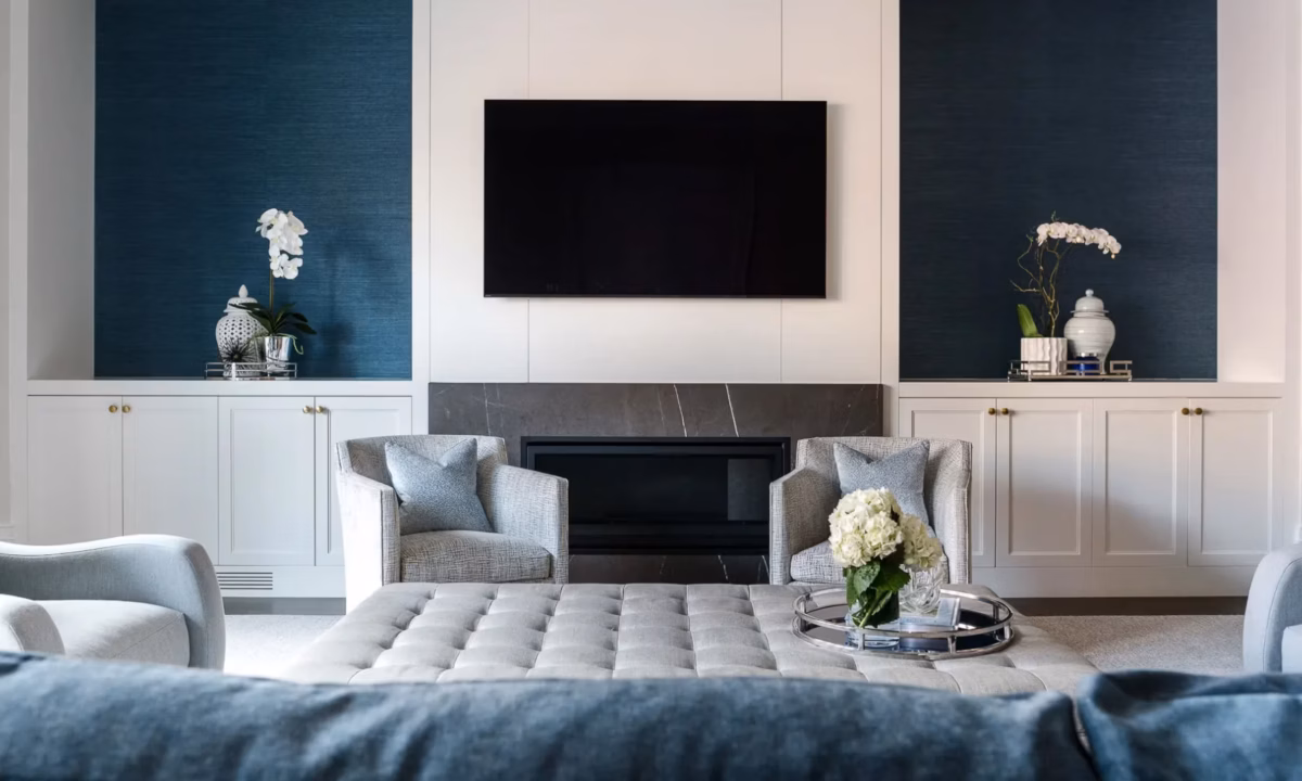 image of blue themed living room with a tv hanging over the fireplace