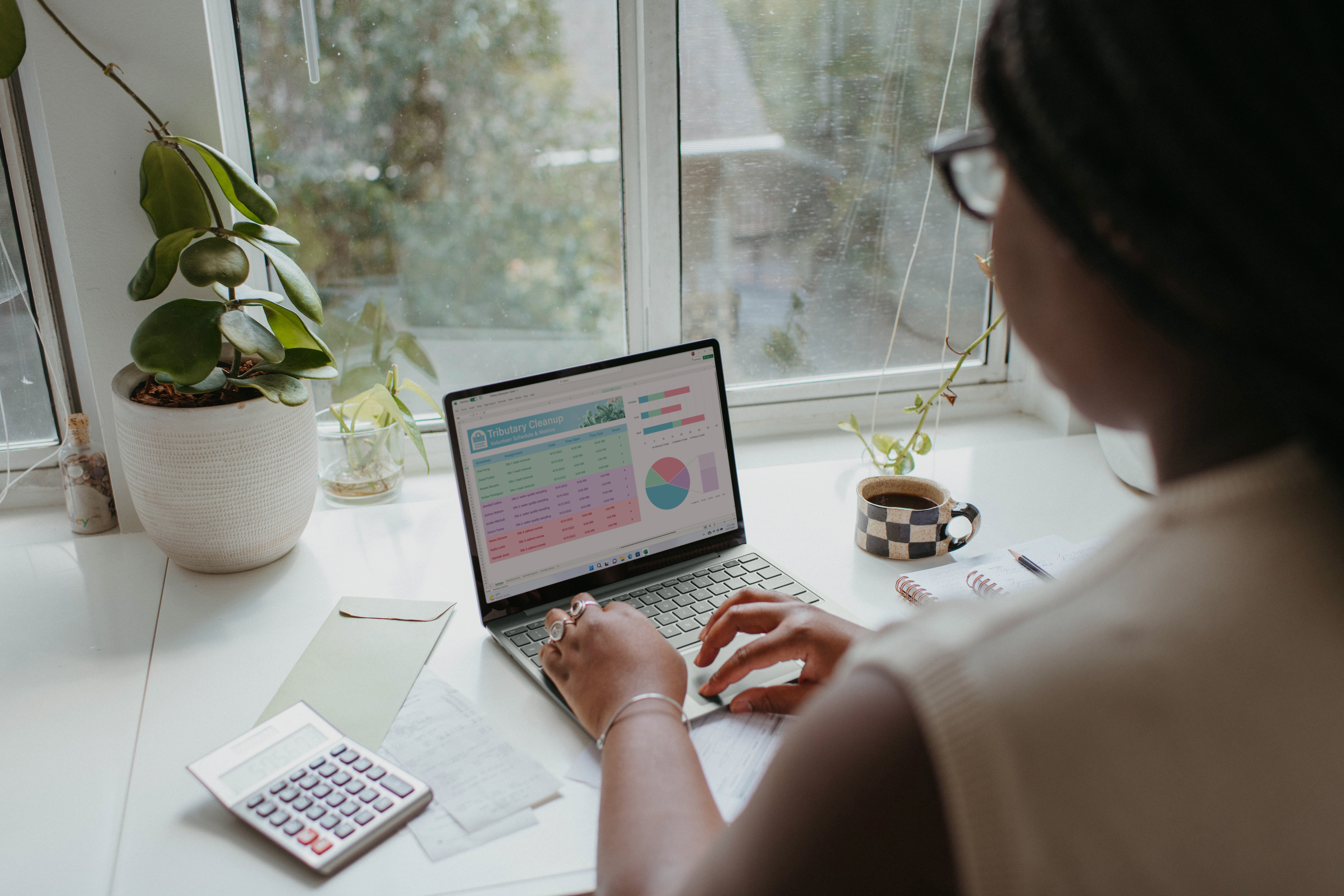A realtor managing their real estate marketing expenses with the help of a guide on her laptop.