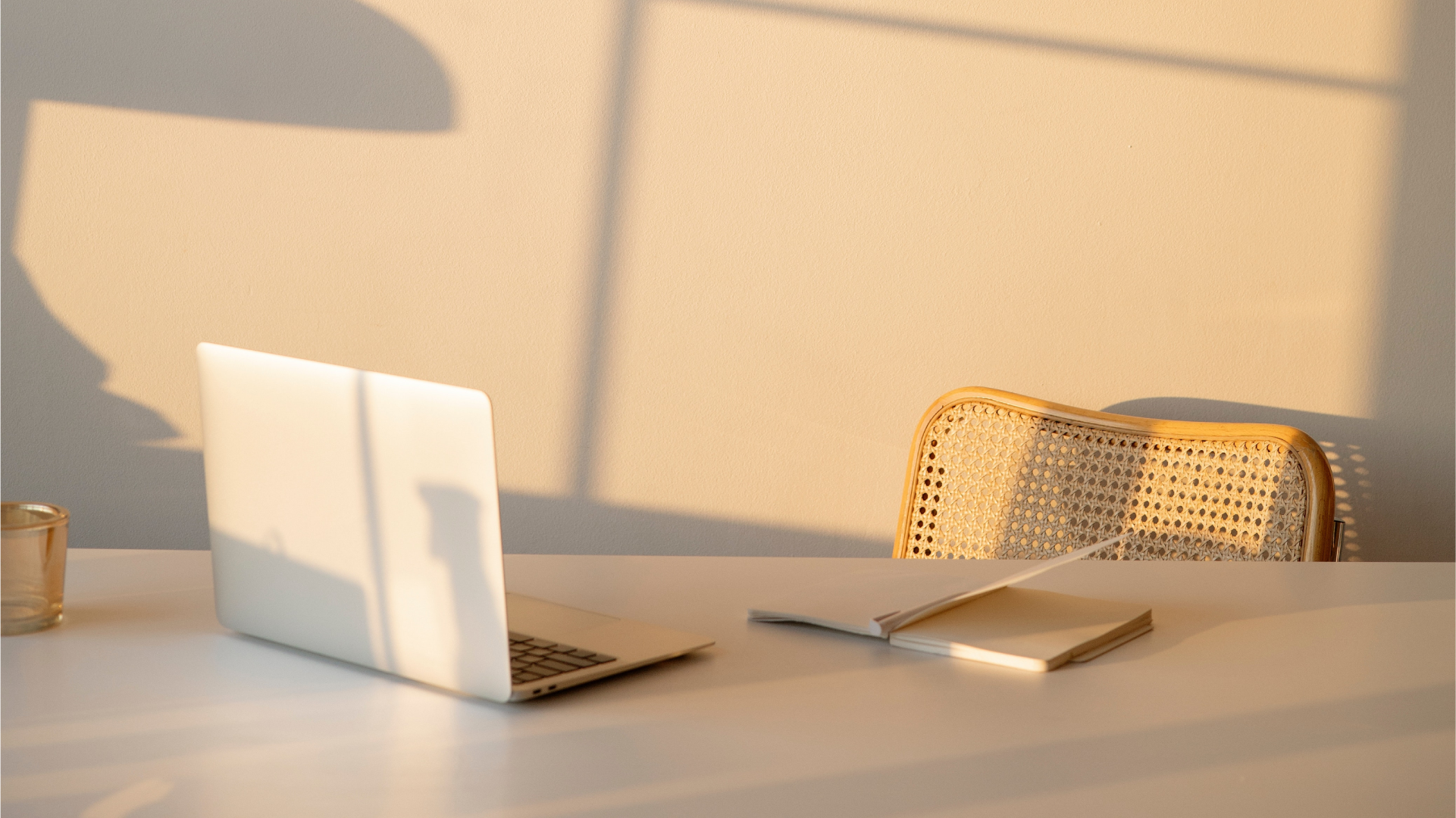 image of laptop sitting at desk during sundown