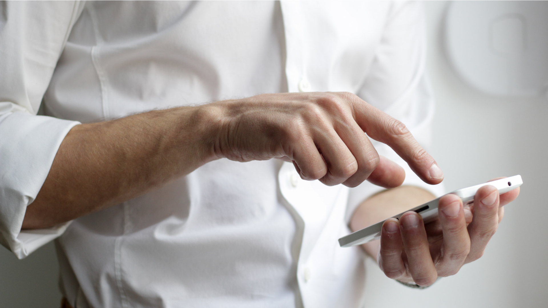male real estate agent pointing at iPhone screen