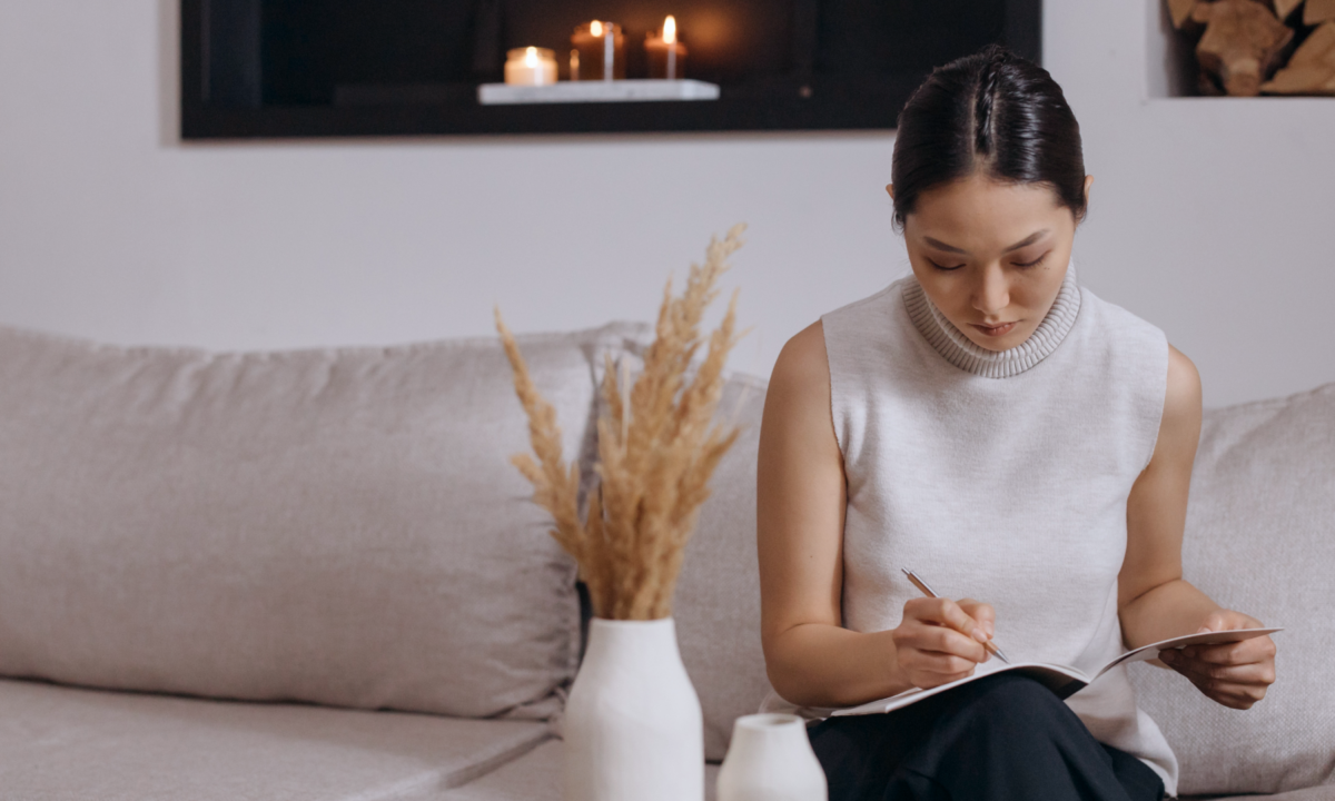 Businesswoman on white couch with tablet looking through list of real estate keywords to find the right one to use