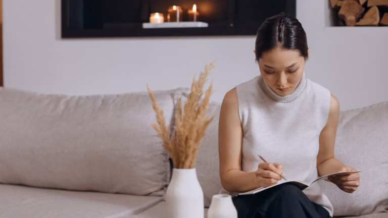 Businesswoman on white couch with tablet looking through list of real estate keywords to find the right one to use