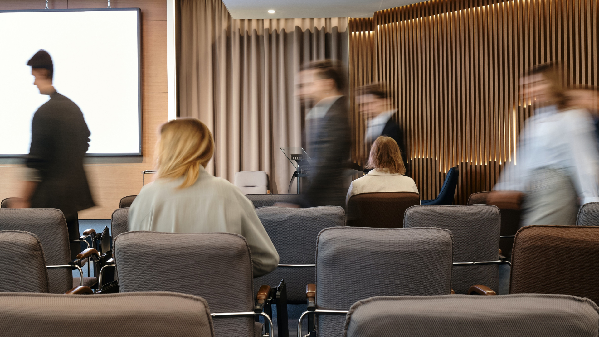 image of real estate agents in a room listening to real estate podcasts