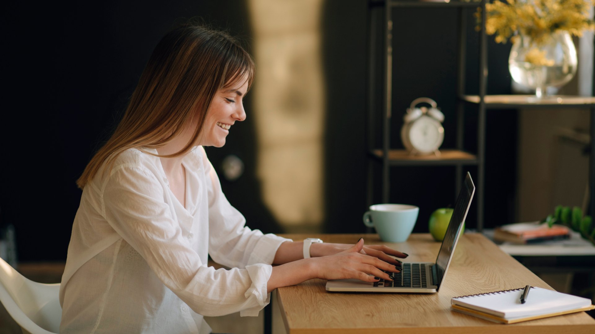 agent typing email communication to real estate database on laptop