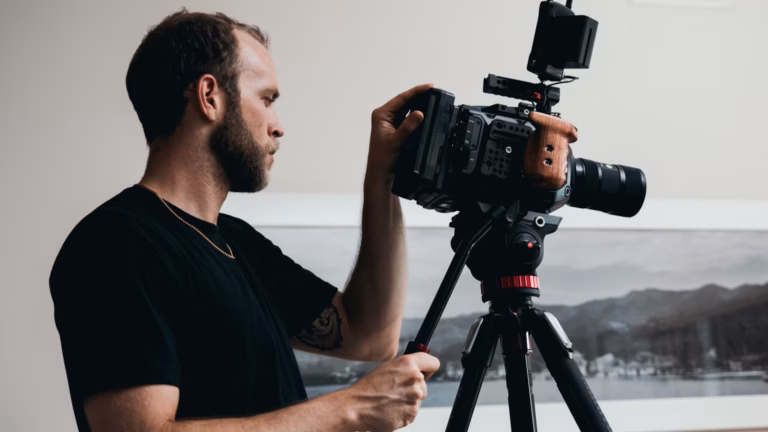 photographer wearing a black shirt using camera and tripod to demonstrate how to take real estate photos