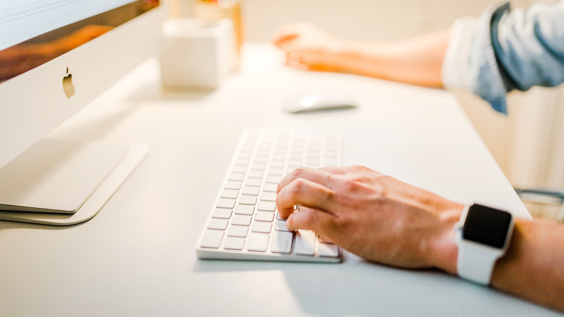 image of handing typing on keyboard at desk