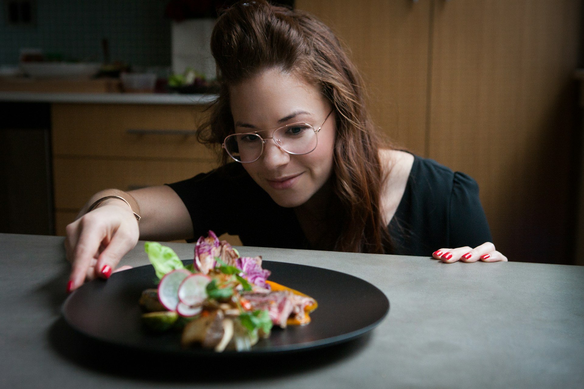 A home chef enjoys looking a meal prepared with tools from their realtor's closing gift