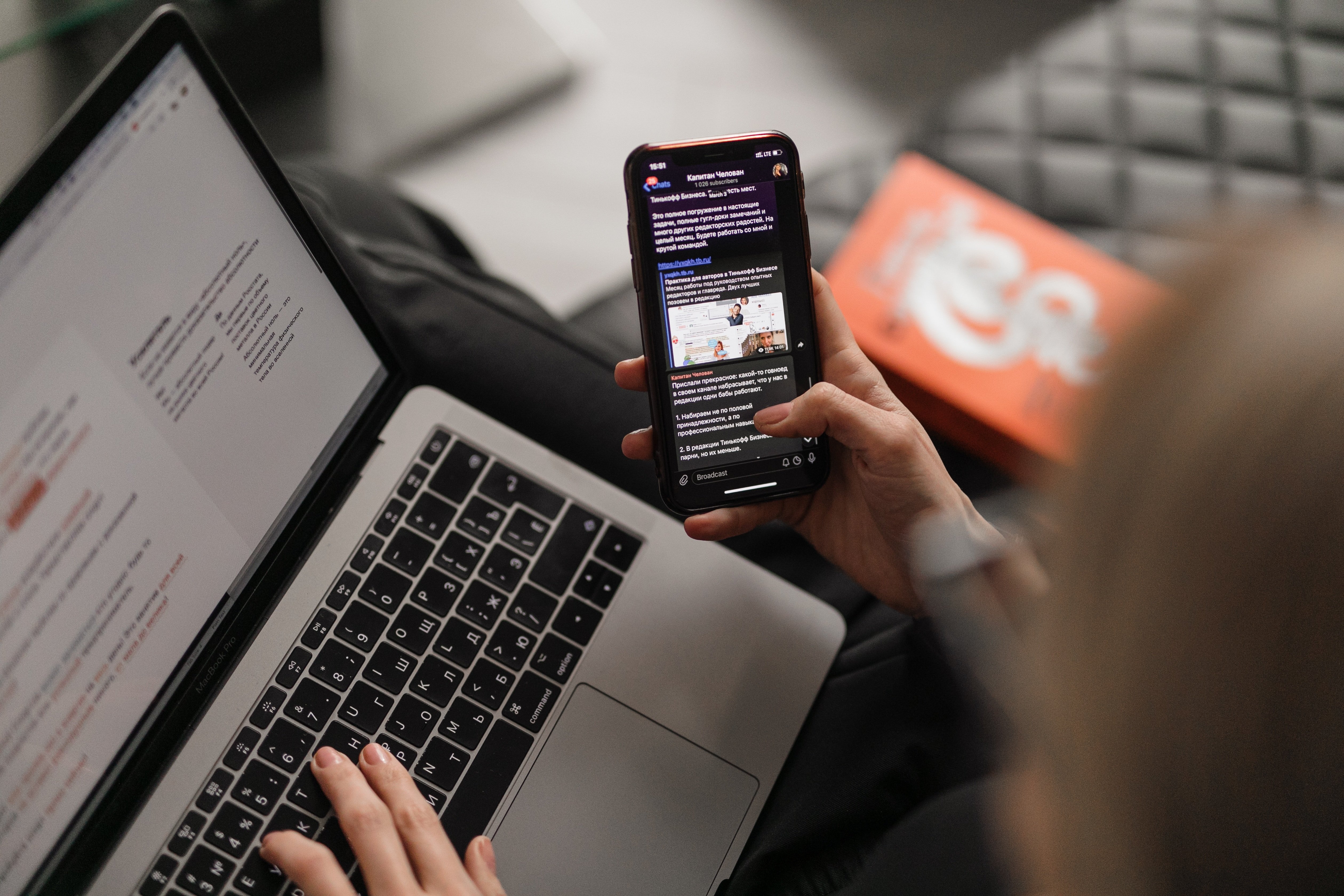 agent looking at email on phone while use laptop